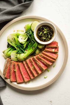 an air fryer tuna steaks healthy meal on a plate with greens and sauce