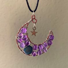 a necklace with purple beads and a star hanging from it