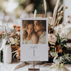 a table with flowers and wine glasses on it is set up for a wedding reception