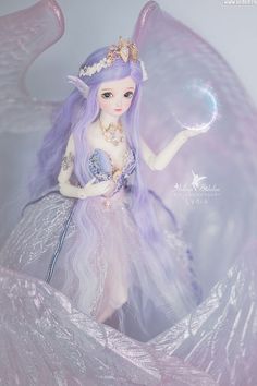 a doll with purple hair holding a crystal ball