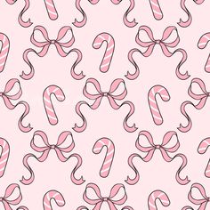 candy canes with pink bows on a light pink background seamless wallpaper pattern