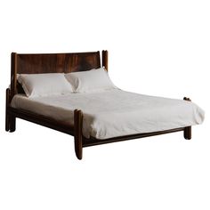 a wooden bed with white sheets and pillows on it's headboard, against a white background