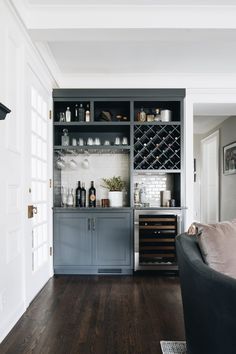 a living room filled with furniture and a wine rack