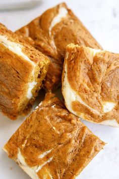 several pieces of cake sitting on top of a white counter