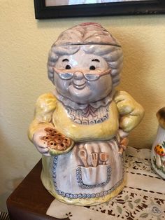 a ceramic statue of an old man holding a cookie