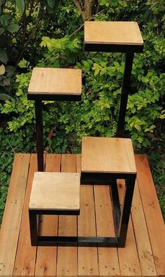 three wooden tables sitting on top of a wooden platform