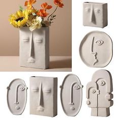 four different shapes and sizes of vases with flowers in them, including one man's face