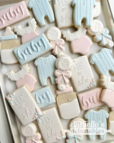 baby shower cookies are arranged on a cookie sheet