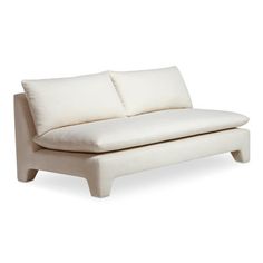 a white couch with two pillows on it