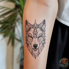 a woman's arm with a tattoo of a wolf on the left side of her body