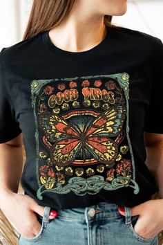 Spread good vibes with our Butterfly Graphic Tee! Made with high quality materials and a stylish design, this tee will make a statement wherever you go. The butterfly graphic adds a touch of beauty and positivity to your wardrobe. Feel good and look good with our Good Vibes Graphic Tee! Unisex Crew Neck Short Sleeve .High Quality Direct To Film Printed Graphic Design.100%COTTON,HEATHER(52%COTTON,48%POLY),ATH.HEATHER,BLACK HEATHER(90%COTTON,10%POLY) Good Vibes Graphic, Cute Butterfly Print Crew Neck T-shirt, Trendy Cotton T-shirt With Butterfly Print, Cheap Butterfly Print Graphic T-shirt, Black Cotton T-shirt With Butterfly Print, Spring Short Sleeve T-shirt With Butterfly Print, Concert Festival, Butterfly Graphic, Romper And Jacket