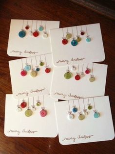 four christmas cards with buttons on them and the words diy christmas cards attached to them