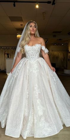 a woman in a wedding dress posing for the camera