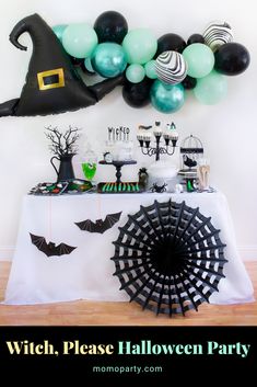 a table topped with balloons and halloween decorations