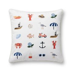 a white pillow with an assortment of different items on it, including umbrellas and boats