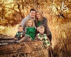 a family posing for a photo in front of some trees and grass with the caption kristi sherie photography