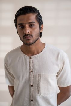 This Dawning Layered Shirt comes in a calm and soothing color. This layered shirt with an interesting play of panelling of two fabrics, Kala Cotton and self-checked, is undyed and unbleached. Replete with a classic round neck, this half-sleeve shirt comes with two functional pockets. Stitches of Kantha, a form of Indian hand embroidery, line the placket, neckline and pockets. *This item is a final sale and not eligible for returns or exchanges. *This item can take up to 14 business days to ship Indian Hand Embroidery, Half Sleeve Shirts, Soothing Colors, Sustainable Clothing, Half Sleeve, Half Sleeves, Hand Embroidery, Final Sale, Sleeve Shirt