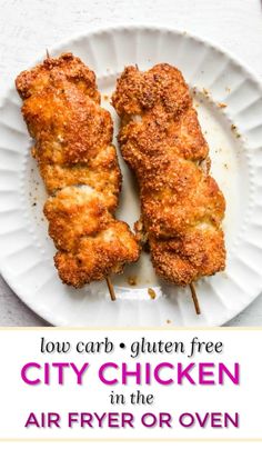 two chicken skewers on a white plate with the title low carb gluen free city chicken in the air fryer or oven