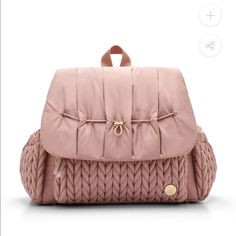 a pink backpack with braiding on the front