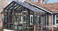 a house that has some glass on the side of it's roof and windows