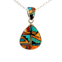 Vintage Southwestern Sterling Silver Inlay Pendant: This inlay pendant features a combination of Turquoise, Black Onyx and Spiny Oyster, beautifully handcrafted with expert attention to detail. Immerse yourself in true Southwestern style with this exceptional addition to any collection. Stones: Turquoise, Onyx, Spiny Oyster, Lapis Setting: 1".25 L x 1"W (bottom) Size: 2" L w/bail (a tad under 2") Metal: Sterling Silver Weight: 12.9 Grams Includes 16" SS Rolo Chain This listing is for (1) Pendant only Explore our curated selection of Vintage Pendants + Necklaces here. Discover the entire 'Silver Raven' Vintage Collection for yourself. Southwestern Turquoise Inlay Pendant Necklace, Southwestern Style Multicolor Turquoise Pendant Necklace, Multicolor Southwestern Turquoise Pendant Necklace, Artisan Oval Necklace With Inlay, Artisan Teardrop Inlay Jewelry, Artisan Oval Inlay Necklace, Artisan Turquoise Pendant Necklace With Inlay, Raven Jewelry, Vintage Pendant Necklace