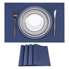 a place setting with blue napkins and gold trimmings on the edge, along with silverware