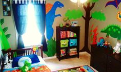 a child's bedroom decorated in dinosaur theme