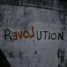 graffiti on the side of a building that says revolution in black and red spray paint