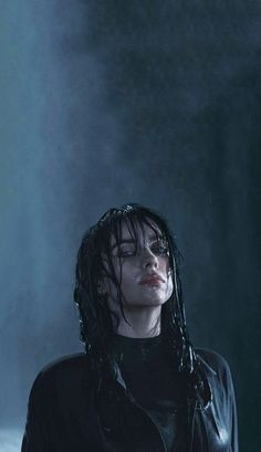 a woman with wet hair standing in the rain wearing a leather jacket and black shirt