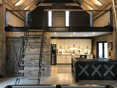 an open floor plan with stairs leading up to the loft