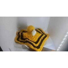 a crocheted yellow and black pot holder