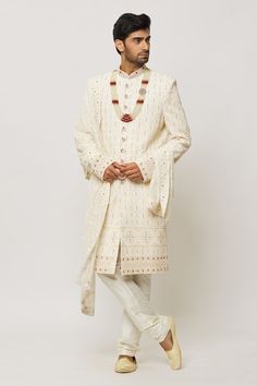 Cream sherwani embroidered with honeycomb patterns, embellished by sequins and pearls. Comes with a churidar. - Aza Fashions Designer Kundan Sherwani With Dupatta, Kundan Sherwani With Dupatta For Designer Wear, Long Sleeve Kundan Traditional Wear For Wedding, Kundan Long Sleeve Traditional Wear For Wedding, Festive Bollywood Sherwani With Kundan, Kundan Traditional Wear With Long Sleeves For Wedding, Diwali Sherwani With Dupatta And Kundan, Festive Embroidered Kundan Sherwani, Bollywood Style Kundan Sherwani With Dupatta