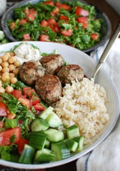 a bowl filled with rice, meatballs and veggies on top of it