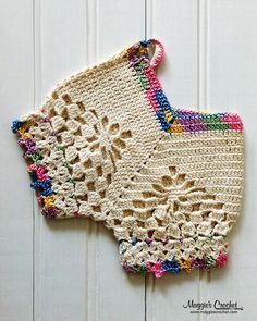 crocheted doily hanging on the side of a white door with wood paneling