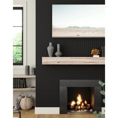 a black and white living room with a fire place in the fireplace, two vases on either side