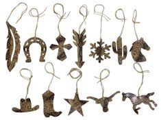 an assortment of metal ornaments hanging from strings on a white background with snowflakes