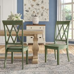 a dining room with blue walls and wooden furniture in the center, along with an area rug on the floor