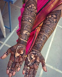 a woman's hand with henna tattoos on it