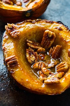 two pumpkins with pecans in the center