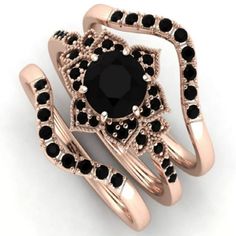 a black diamond ring set on top of each other with two matching rings in the middle