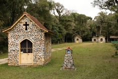 an old stone building with a cross on it