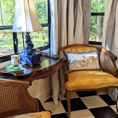 two chairs and a desk in front of a window