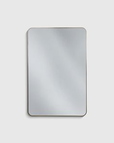 a square mirror on a white wall