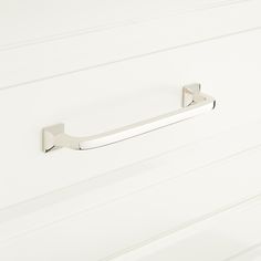 a close up of a bathroom door handle on a white painted wall with horizontal stripes