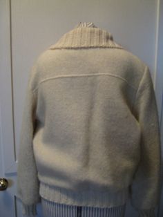 "Hand Made Wool Coat With Sweater Knit Cuffs, Collar And Around The Bottom. Ivory Yellow In Color. Lined With An Acetate Lining. 22\" Ivory Metal Zipper. Possibly From The 1980s with A Blousy Style. Side Front Pockets, Yoke And Top Stitching. Excellent Vintage Condition. No Rips, Tears Or Stains. 1 Very Tiny Place On The Back Of One Sleeve That The Weave Is Loose. Jacket Has A Fluffy Sweater Look And Feel. No Size Listed But Probably Best Fits A Womens Medium-Large. Please Check Measurements For Fitted Cream Sweater Coat With Long Sleeves, Cream Wool Long Sleeve Sweater Coat, White Wool Sweater Coat For Work, Classic White Outerwear With Shawl Collar, Classic Long Sleeve Cream Sweater Coat, Classic Cream Wool Sweater Coat, Classic Cream Long Sleeve Sweater Coat, Cream Wool Long Sleeve Outerwear, White Wool Casual Sweater Coat