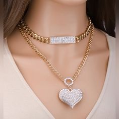 This Beautiful Layered Necklace Will Give The Perfect Fun Touch To Any Outfit. Heart Shaped Crystal Jewelry With Chain, Crystal Heart Chain Jewelry, Trendy Heart Shaped Rhinestone Jewelry, Heart Shaped Crystal Necklace With Adjustable Chain, Gold Crystal Heart Necklace, Crystal Heart Necklace With Bling, Trendy Heart-shaped Alloy Chain Necklace, Gold Crystal Heart Pendant Necklace, Heart-shaped Crystal Chain Jewelry