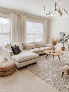 a living room filled with furniture and a large rug on top of a carpeted floor