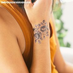 a woman with a flower tattoo on her arm