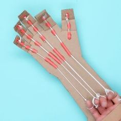 a hand holding a brown bag with red and white toothbrushes in it