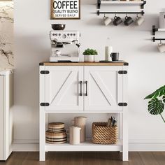 a kitchen with white cabinets and shelves filled with coffee items on top of wooden flooring